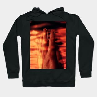 Digital collage and special processing. Hand near soft light. Soft and calm. To exist. Orange and warm. Hoodie